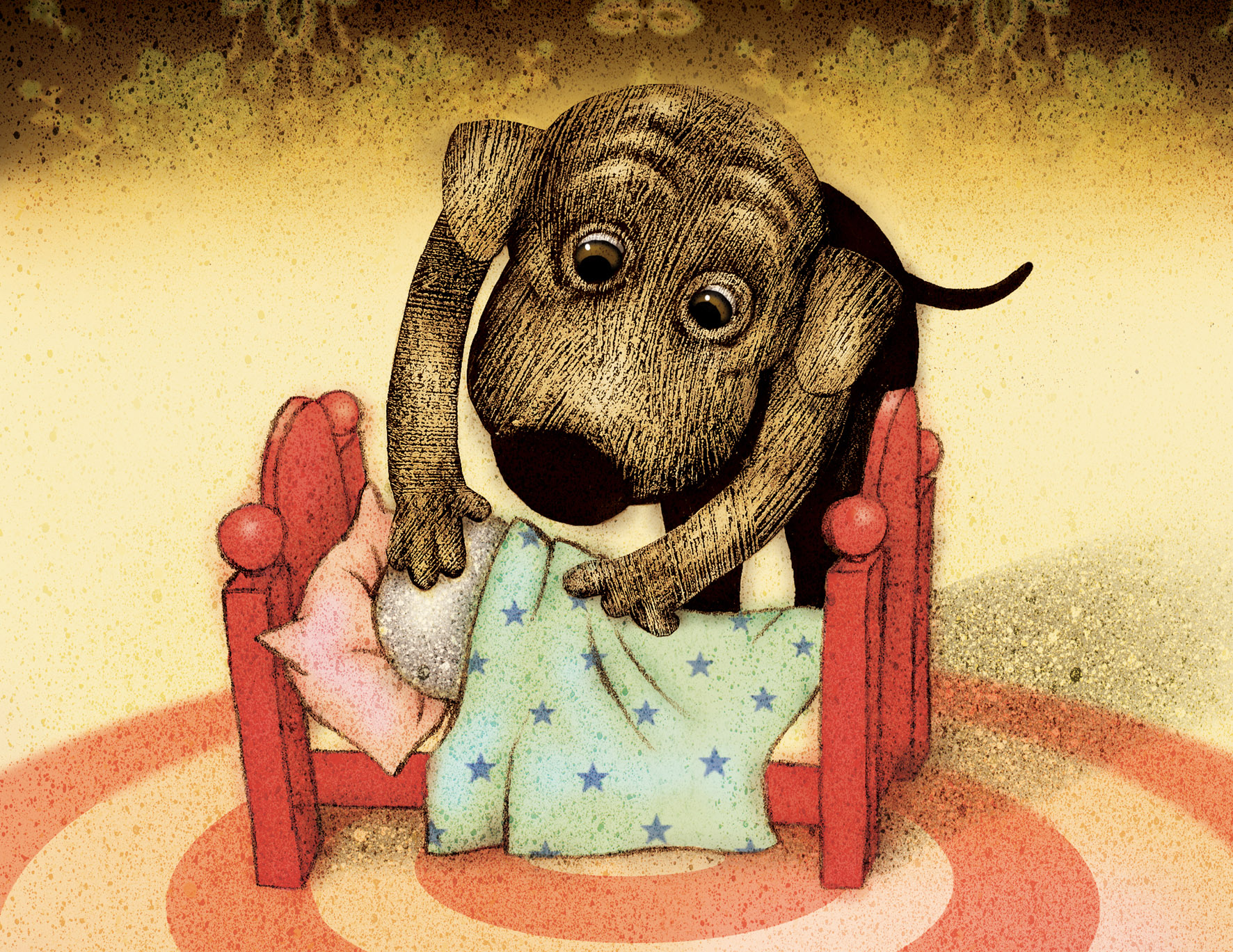 Hunden Aston bäddar ner en sten i en liten säng. 