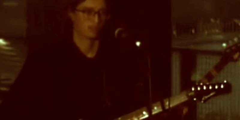 En kille med glasögon och gitarr