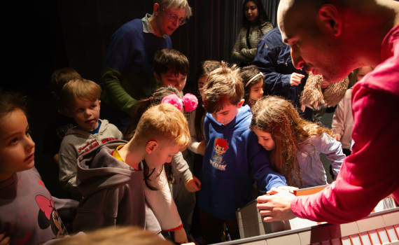 Glad engagerade förskolebarn som tittar på teater