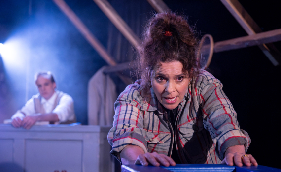 Vanna Rosenberg som skjuter en flyttlåda framför sig, i bakgrunden syns Fredrik Meyer vid pianot.