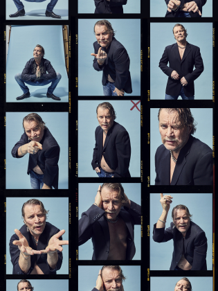 Medelålders man med grått hår och mustasch i svart kavaj och jeans poserar och gestikulerar mot blå bakgrund, collage.